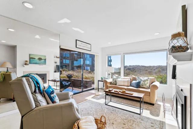 a living room with furniture and a floor to ceiling window