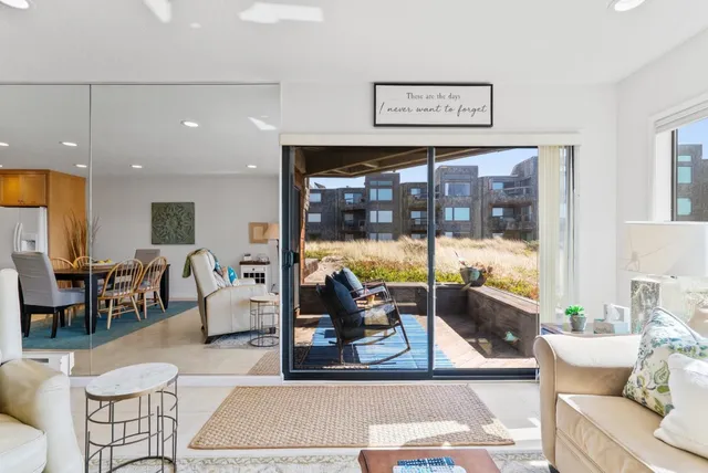 a living room with furniture a rug and a large window