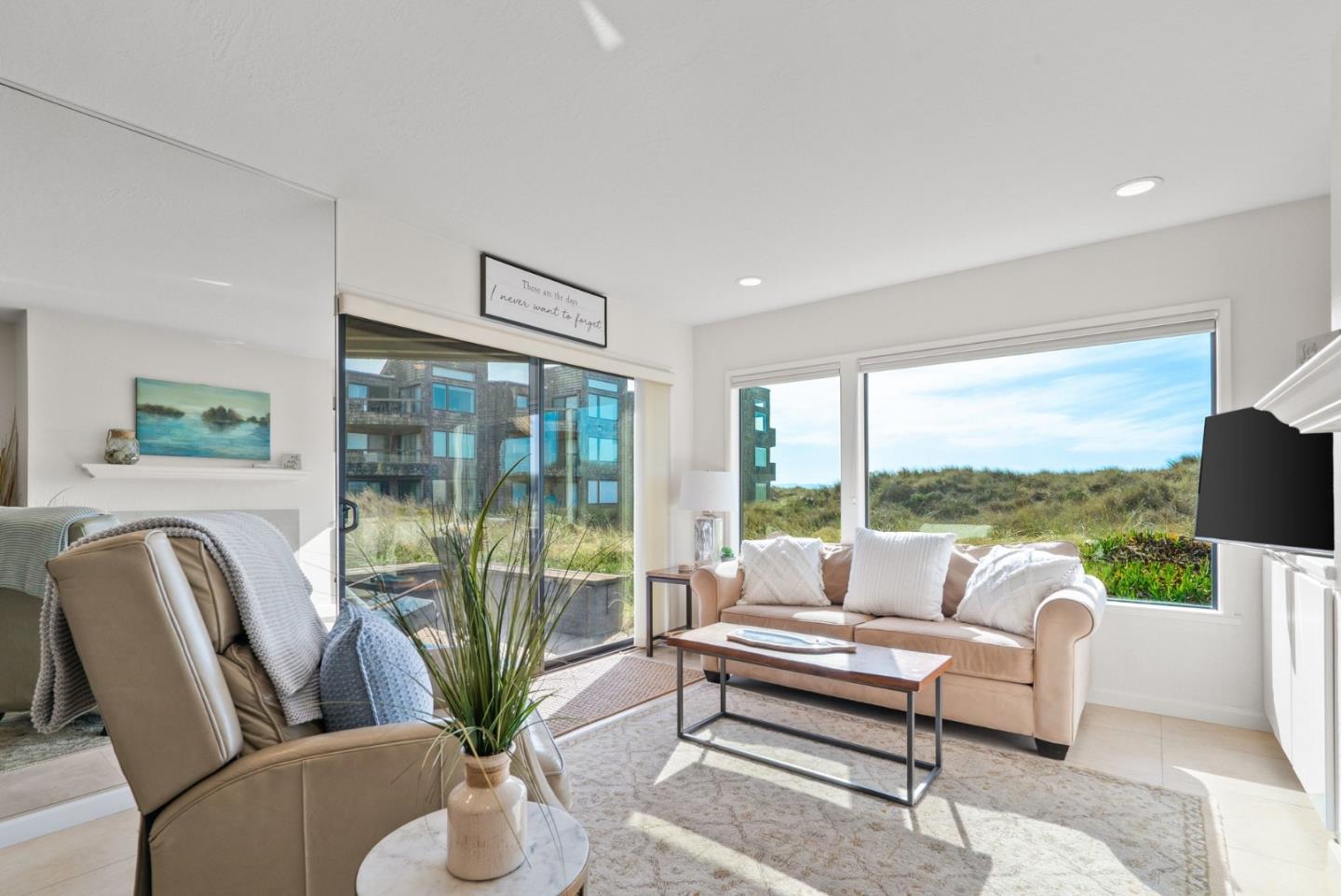 101 Shell Road, Unit 208 Watsonville, CA 95076 - Photo 5 of 26 a living room with furniture tv and large windows