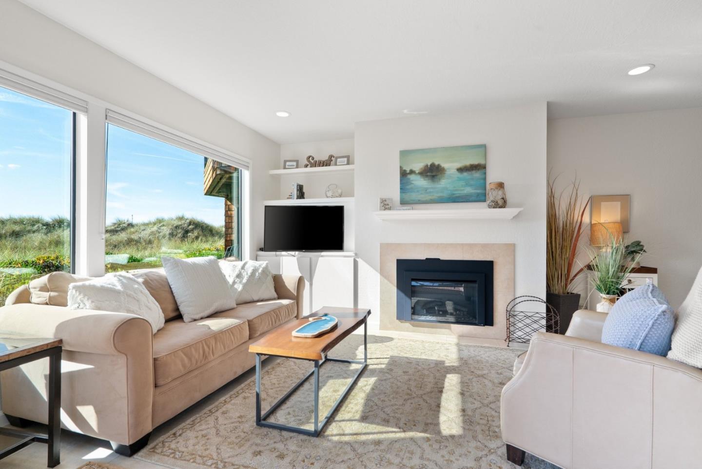 101 Shell Road, Unit 208 Watsonville, CA 95076 - Photo 9 of 26 a living room with furniture a large window and a fireplace