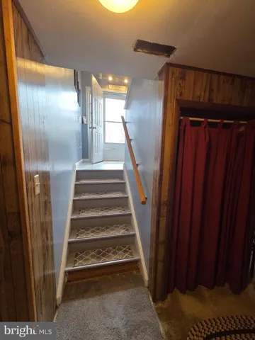 a bedroom with a bed and a lamp on dresser