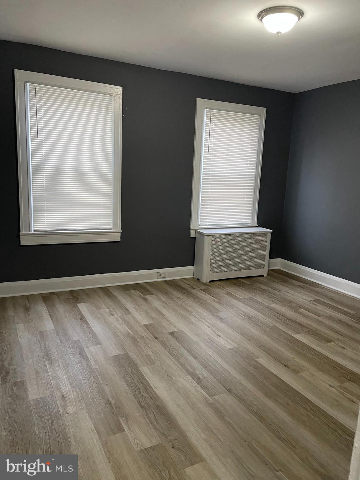3211 Chesterfield Avenue Baltimore, MD 21213 - Photo 11 of 26 an empty room with wooden floor and windows