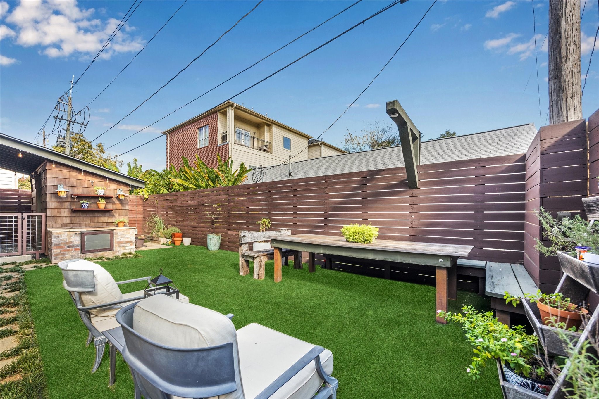 512 Archer Street Houston, TX 77009 - Photo 36 of 40 Enjoy effortless outdoor living in this low-maintenance turfed backyard. On the left, a built-in storage cabinet with a countertop provides the perfect spot to pot flowers, arrange plants, or craft your own little garden oasis.