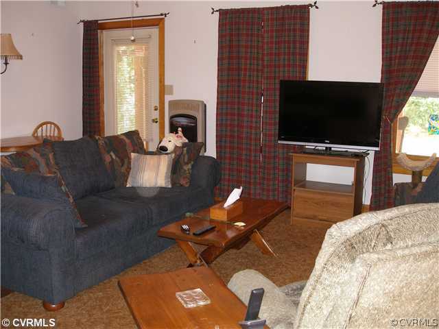 14206 Spring Gate Road Midlothian, VA 23112 - Photo 7 of 10 a living room with furniture and a flat screen tv