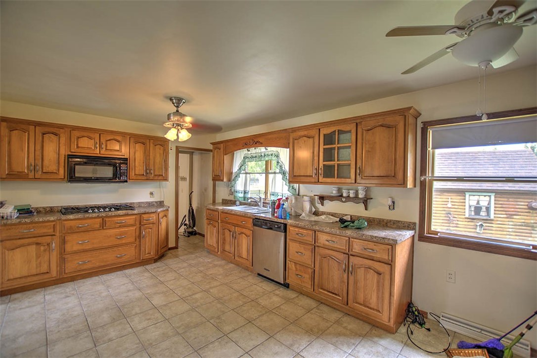 3875 East Maynor Street Decatur, IL 62521 - Photo 17 of 32 a large kitchen with stainless steel appliances granite countertop a sink and cabinets