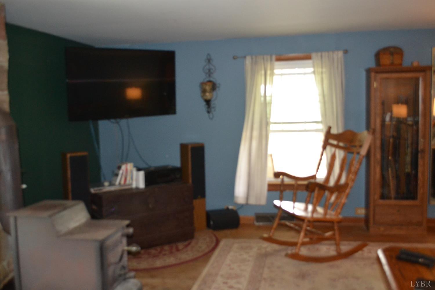 6387 Red House Road Rustburg, VA 24588 - Photo 15 of 38 a work room with furniture a flat screen tv and a window