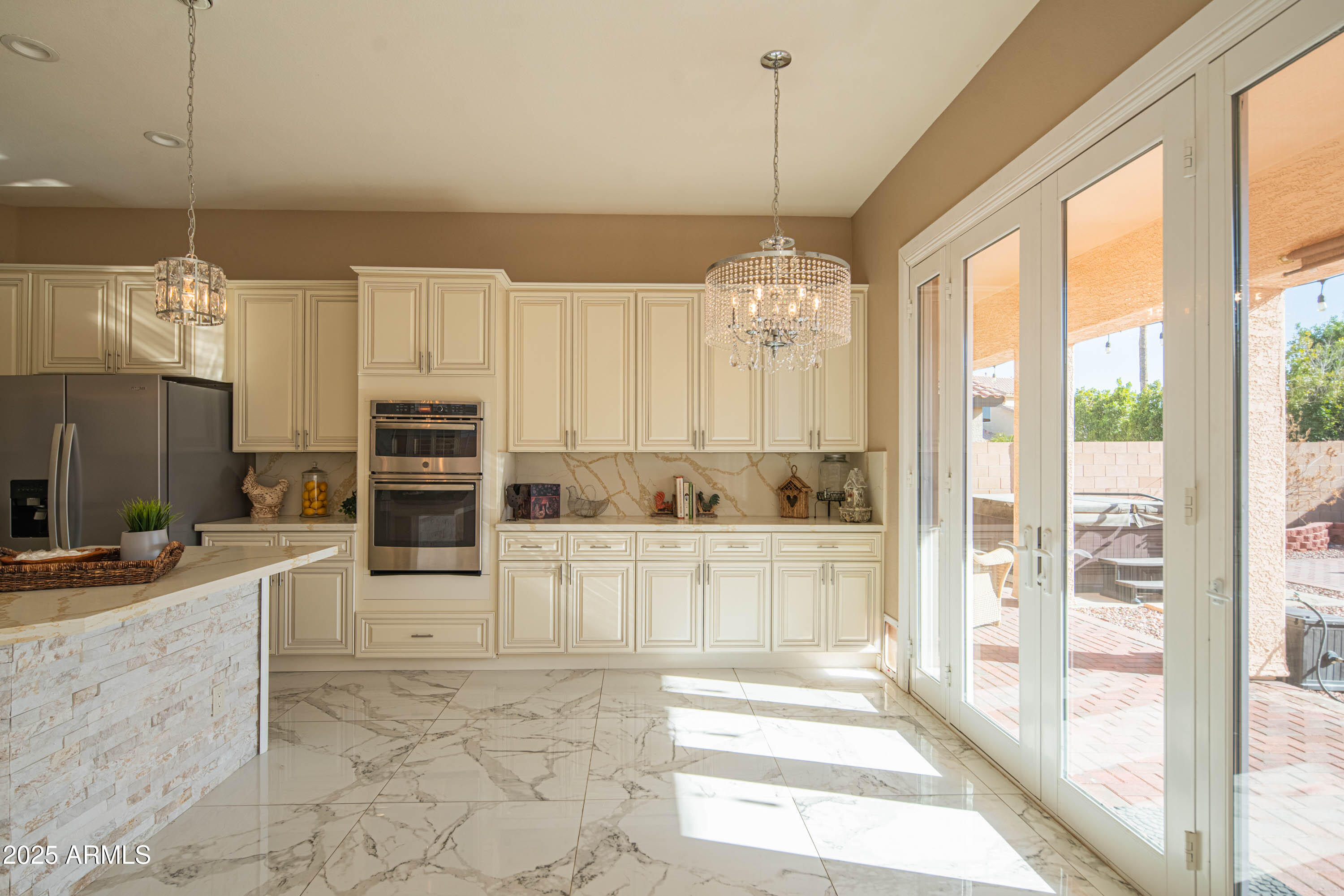 6811 West Del Rio Street, Unit 2 Chandler, AZ 85226 - Photo 15 of 49 a view of a kitchen with kitchen island granite countertop a refrigerator and a stove top oven