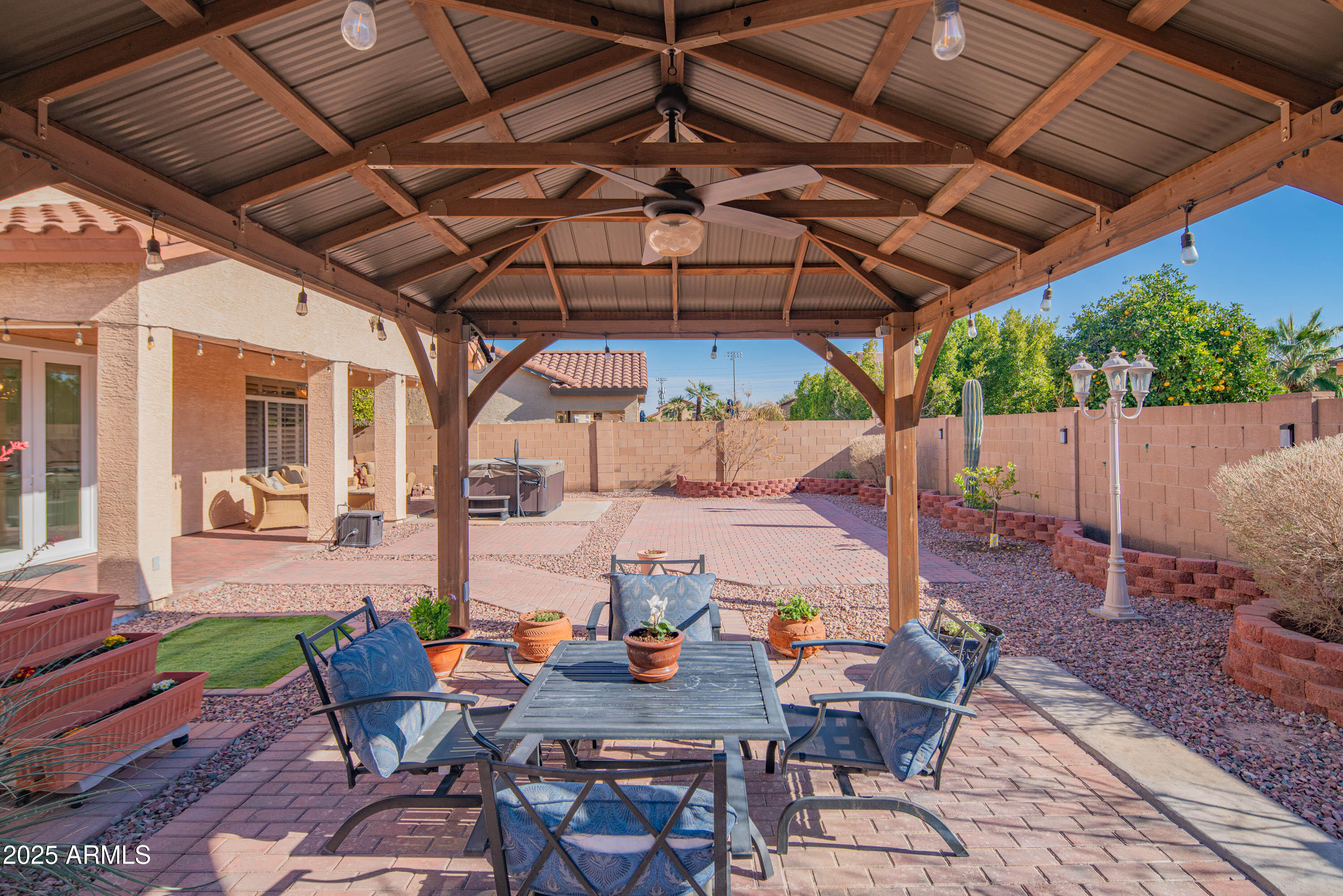 6811 West Del Rio Street, Unit 2 Chandler, AZ 85226 - Photo 40 of 49 a view of patio with table and chairs under an umbrella with a small yard
