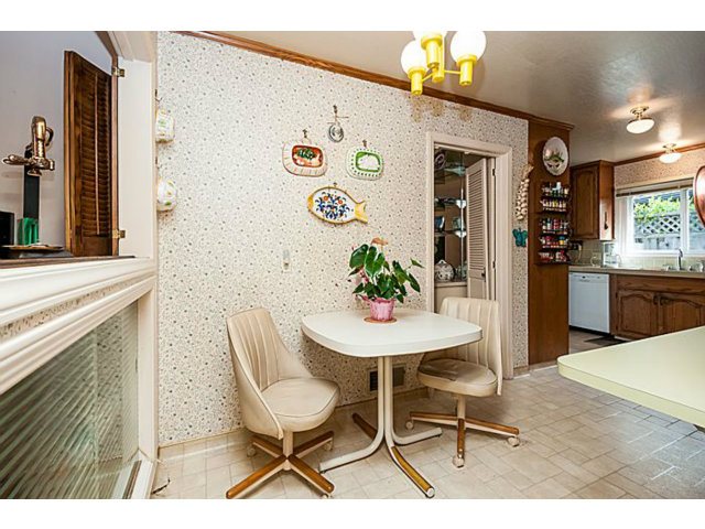 39 De Sabla Road San Mateo, CA 94402 - Photo 11 of 25 a view of a dining room with furniture and a kitchen