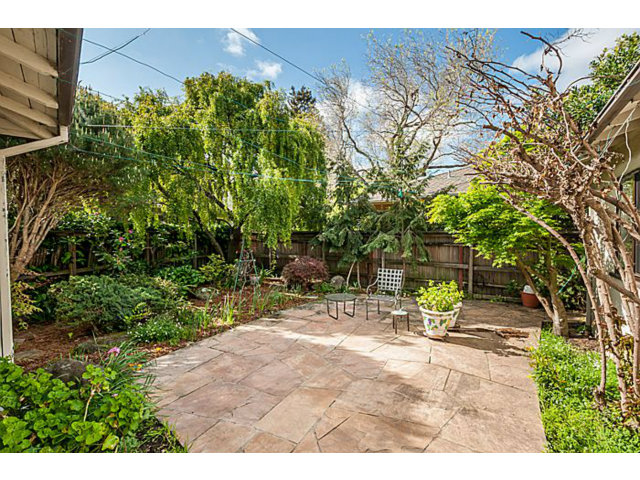 39 De Sabla Road San Mateo, CA 94402 - Photo 24 of 25 a view of backyard with a table and chairs under an umbrella
