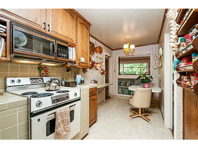 39 De Sabla Road San Mateo, CA 94402 - Photo 10 of 25 a kitchen that has a lot of cabinets in it and stainless steel appliances