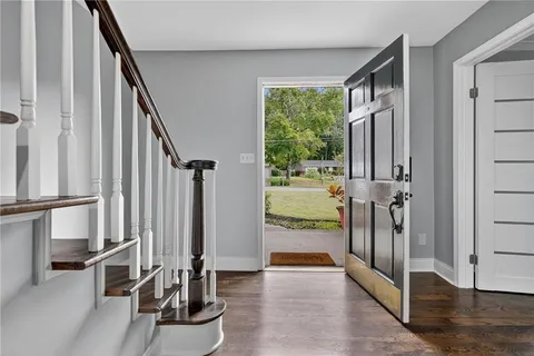 a view of a livingroom with furniture and floor to ceiling window