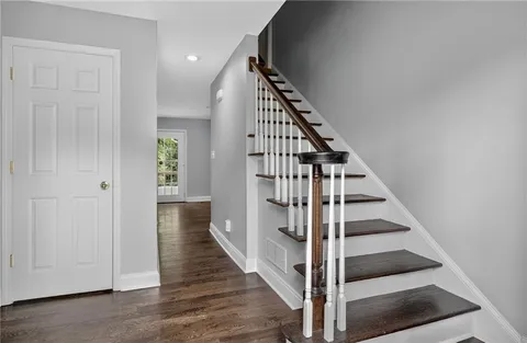 a view of entryway and gallery with wooden floor