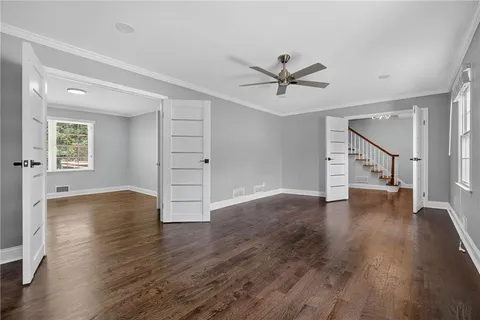 a view of empty room with wooden floor and window