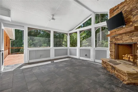 a view of an empty room with a fireplace and a large window