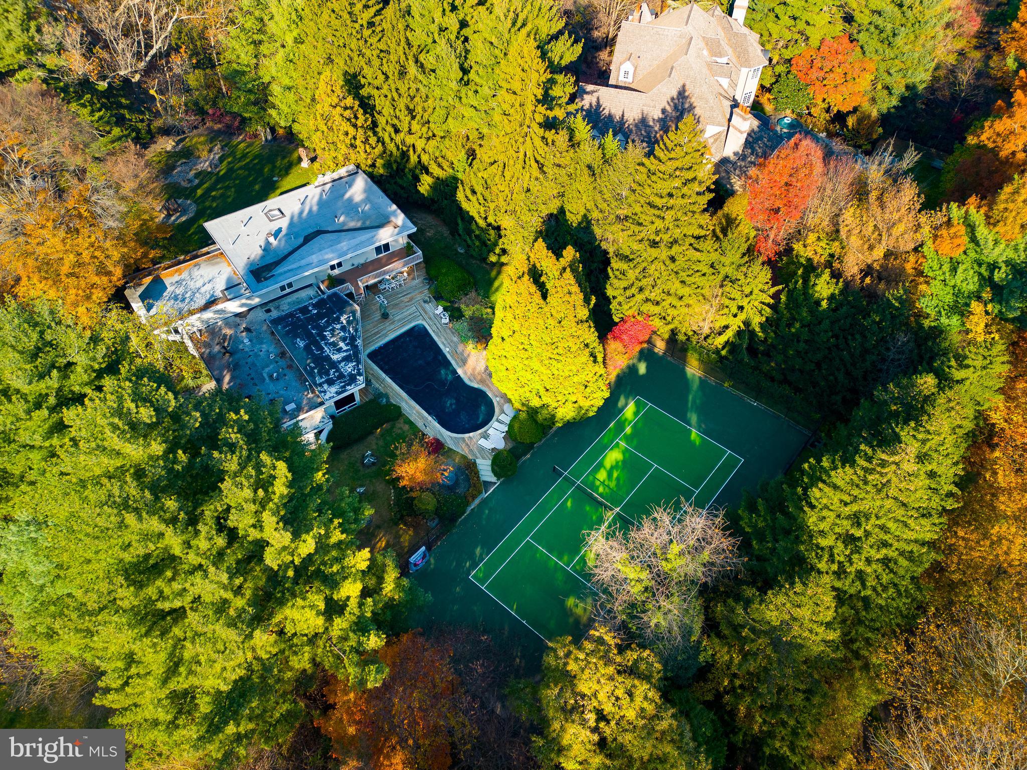 an aerial view of a house with a yard and garden