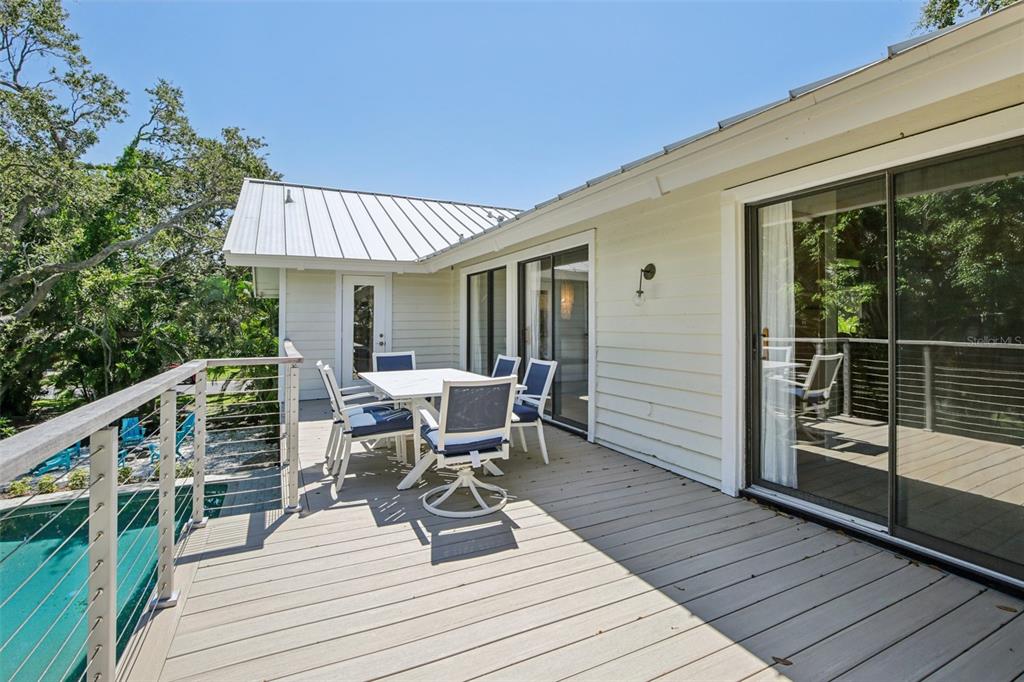 3390 Bayou Sound Longboat Key, FL 34228 - Photo 39 of 59 a roof deck with table and chairs and wooden floor