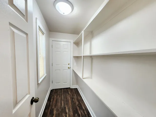 a hallway with wooden cabinets