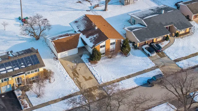 an aerial view of a house with a backyard