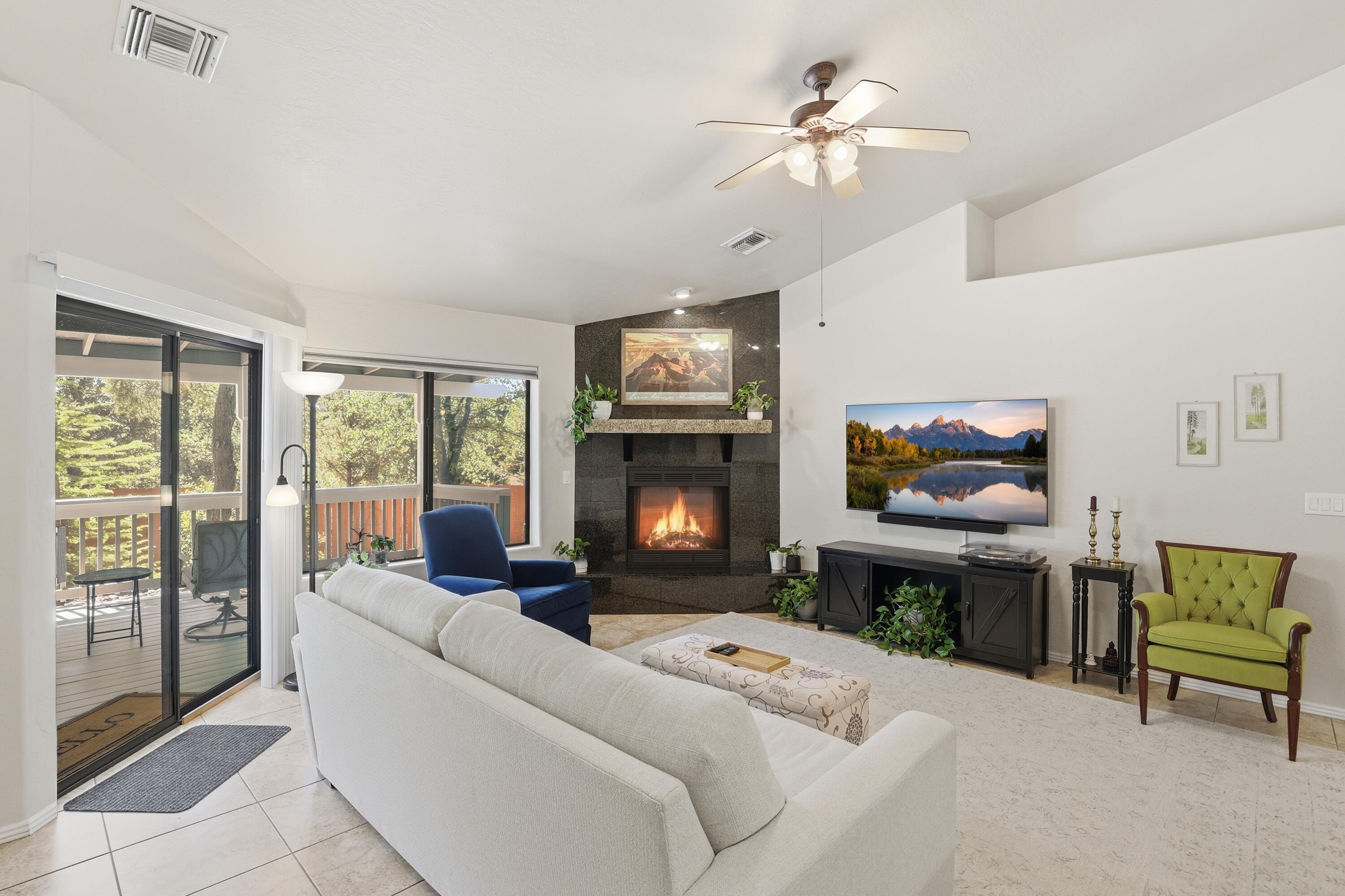 910 West Wagon Trail Payson, AZ 85541 - Photo 5 of 35 a living room with furniture a fireplace and a flat screen tv