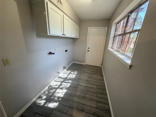 a view of an entryway with wooden floor
