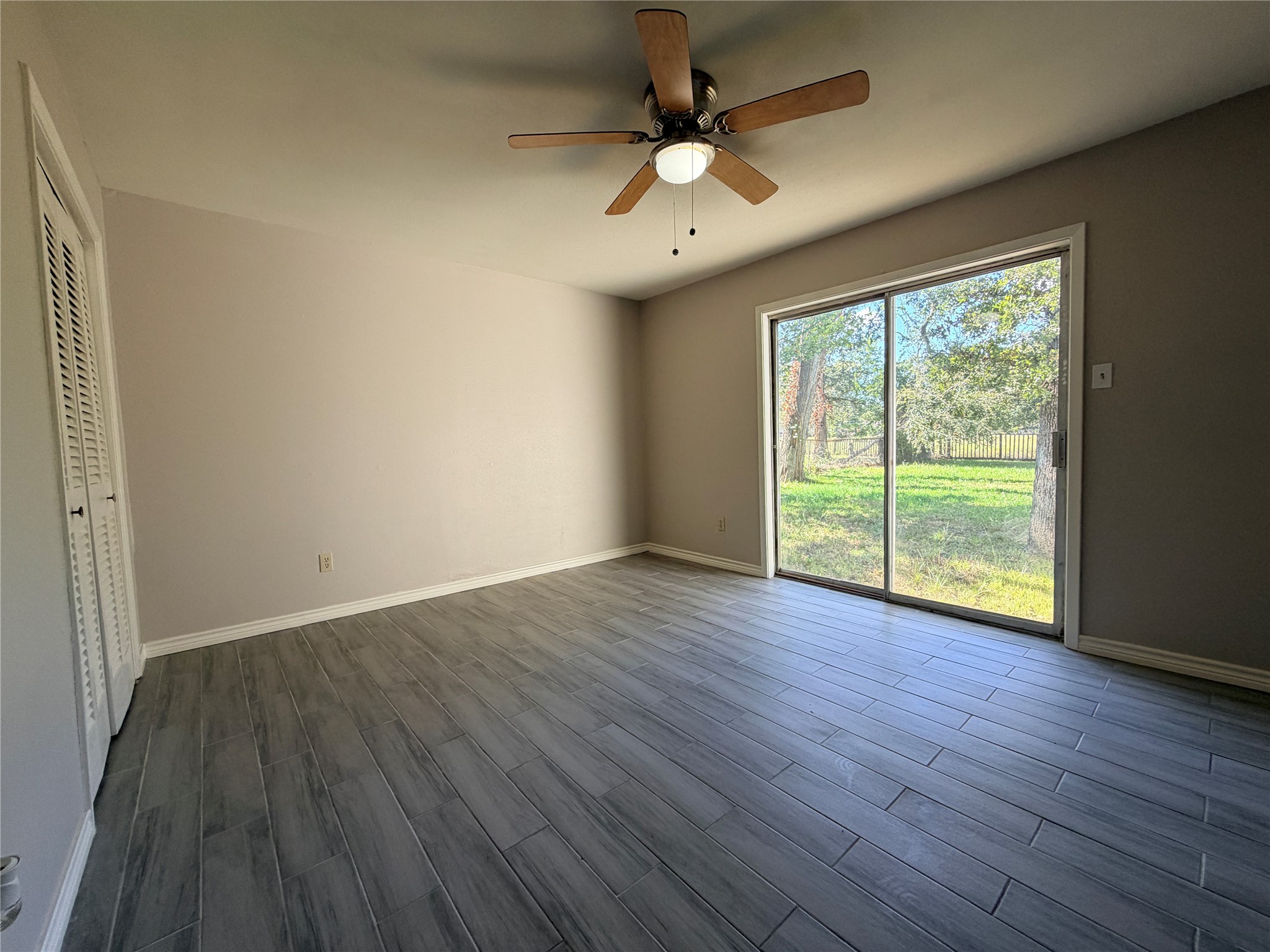 1607 Chestnut Ridge Road Houston, TX 77339 - Photo 13 of 31 a view of an empty room with wooden floor and a window