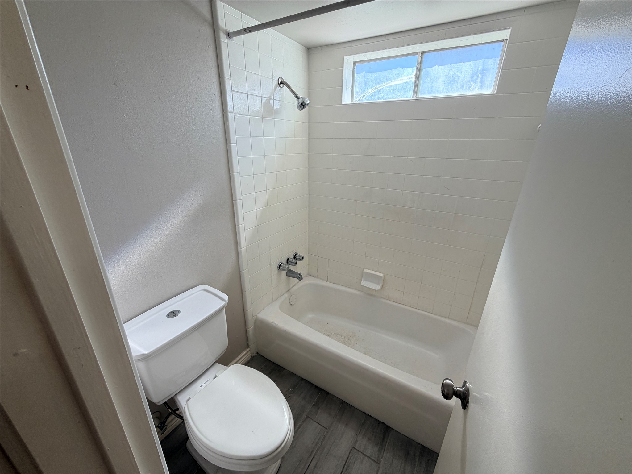 1607 Chestnut Ridge Road Houston, TX 77339 - Photo 19 of 31 a white toilet sitting next to a bath tub