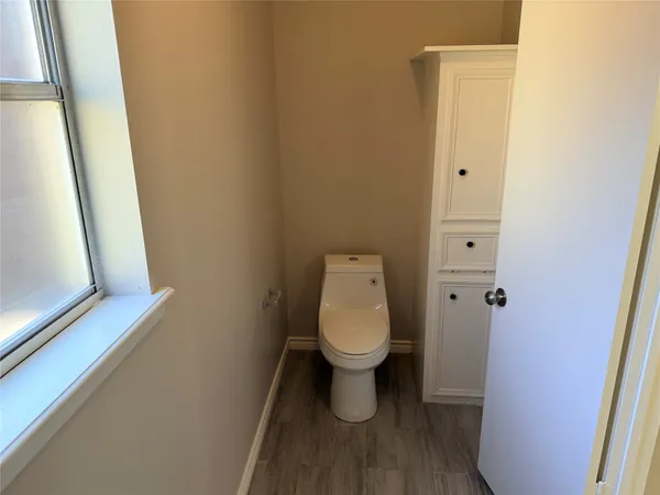 a white toilet sitting next to a small sink