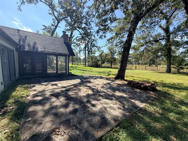 a view of a house with a yard and tree