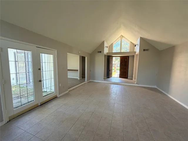a view of livingroom with furniture staircase and front door