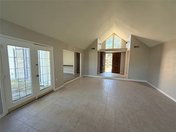 a view of livingroom with furniture staircase and front door