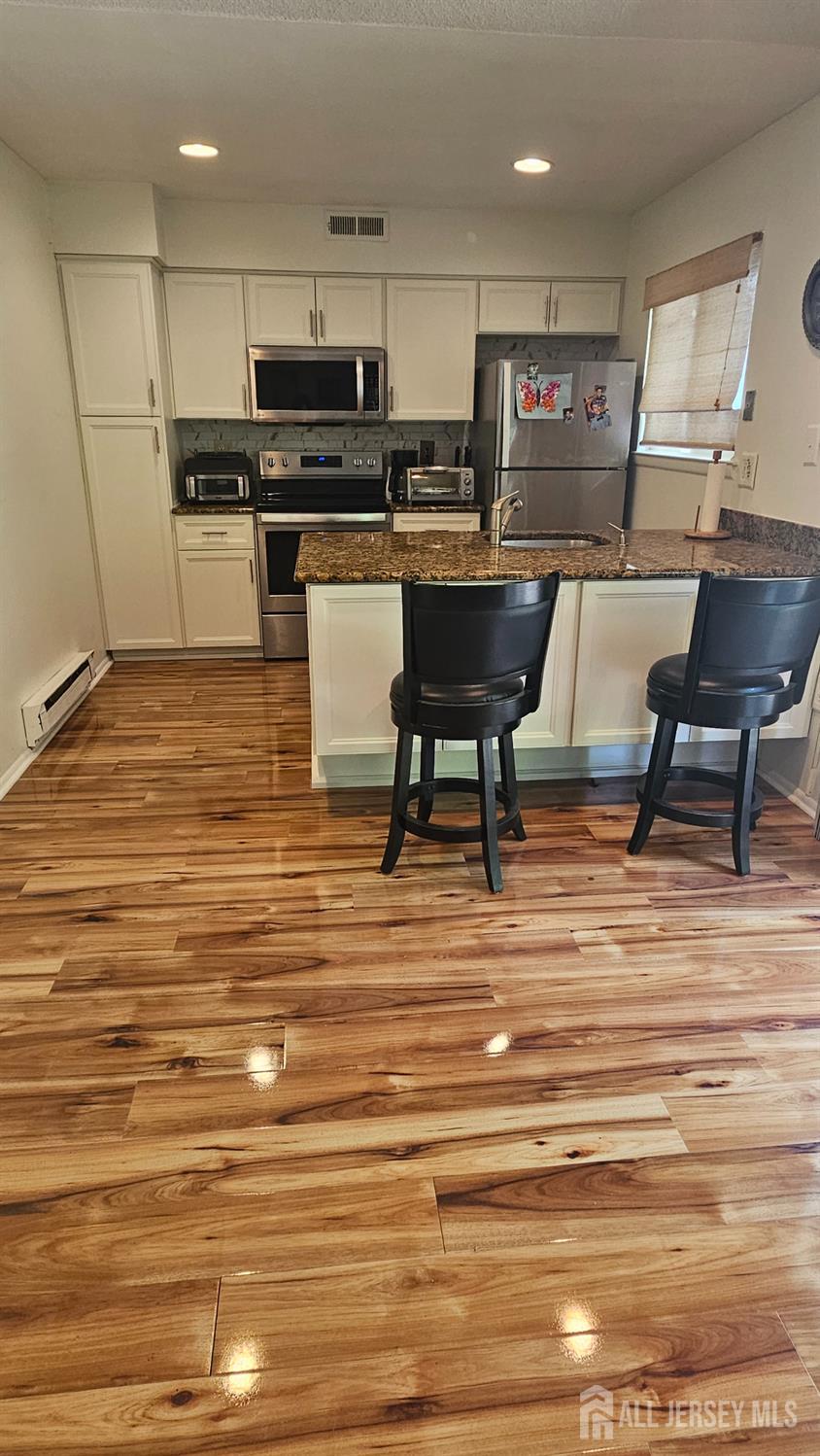 449 B Closter Road, Unit B Monroe Township, NJ 08831 - Photo 4 of 14 a kitchen with a sink cabinets and wooden floor