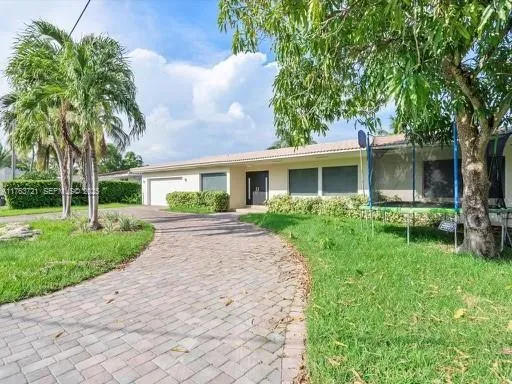a front view of house with yard and green space