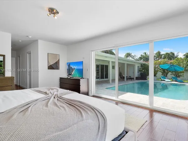 a bedroom with a bed and a view of balcony