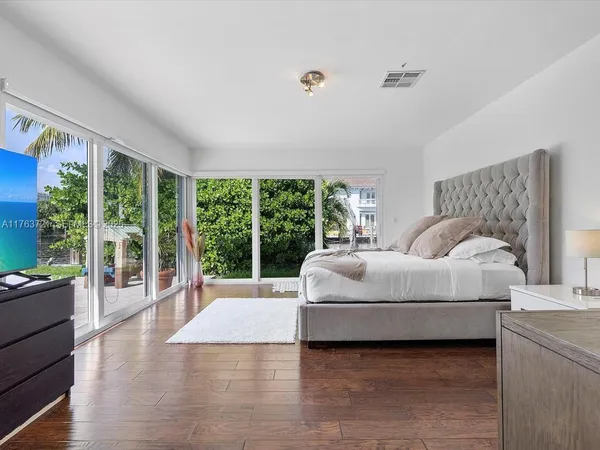 a bedroom with a large bed and a large window