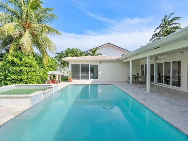 a view of a house with swimming pool and sitting area
