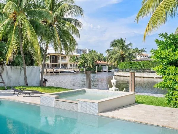 a view of a swimming pool with an outdoor seating
