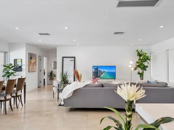 a bedroom with a bed and chandelier