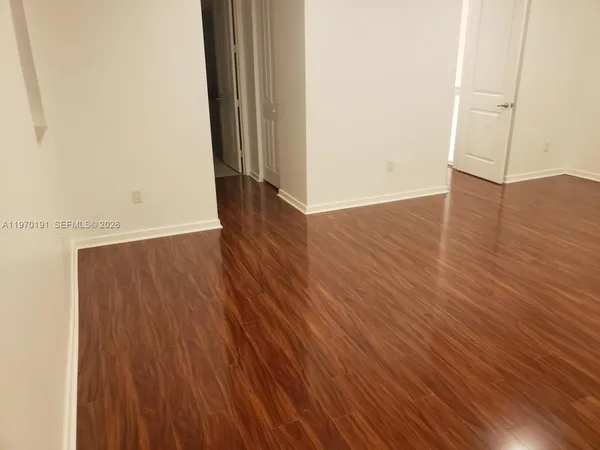 an empty room with wooden floor