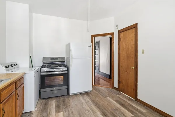 a kitchen with granite countertop a stove and a refrigerator