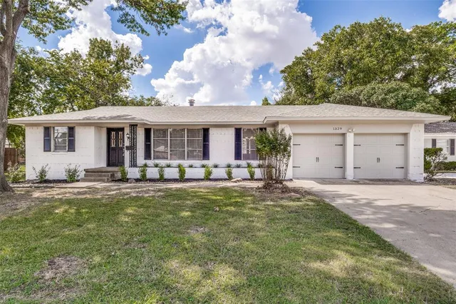 a front view of house with yard and outdoor seating