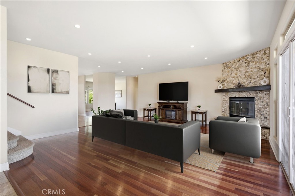 1186 Lydia Lane Fallbrook, CA 92028 - Photo 19 of 68 a living room with furniture a fireplace and a flat screen tv