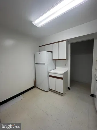 a kitchen with a refrigerator and a stove