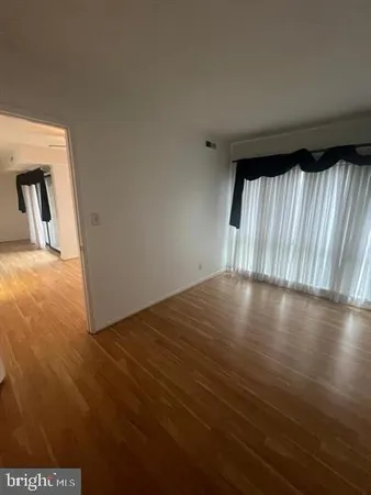a view of wooden floor and windows in a room