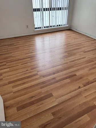 a view of a room with wooden floor