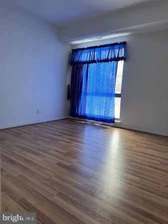 a view of wooden floor and windows in a room