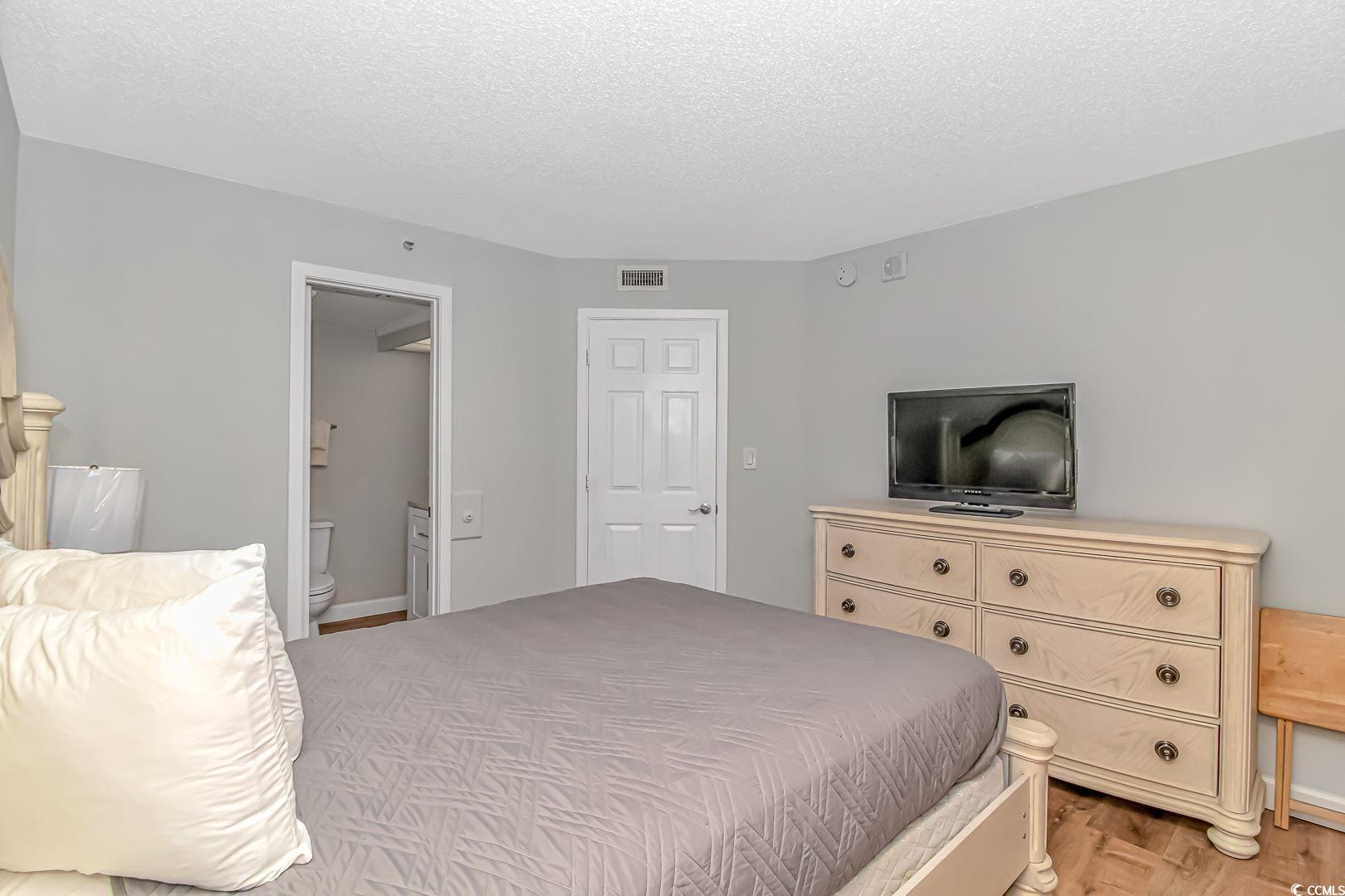 1708 North Ocean Boulevard, Unit PH1 Myrtle Beach, SC 29577 - Photo 11 of 26 Bedroom with light wood finished floors, a texture