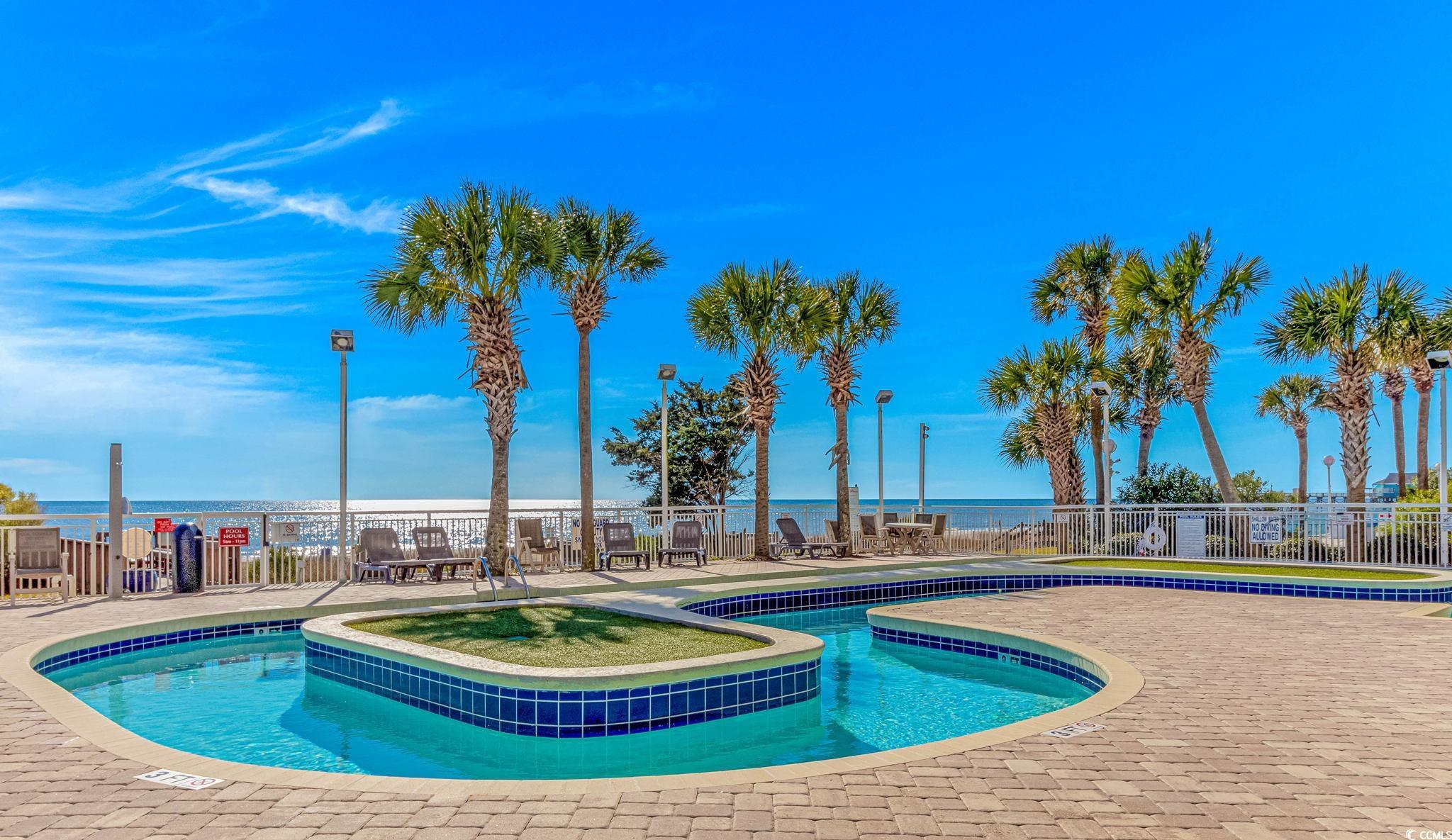 1708 North Ocean Boulevard, Unit PH1 Myrtle Beach, SC 29577 - Photo 23 of 26 Community pool featuring a water view and a patio