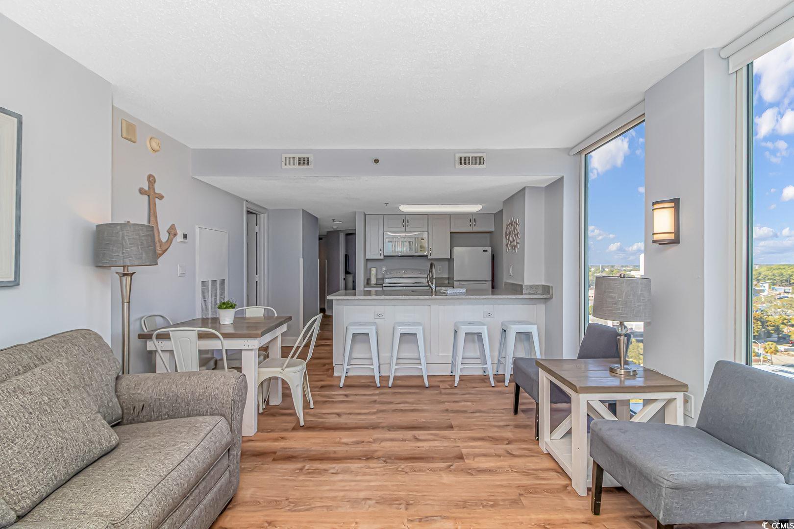 1708 North Ocean Boulevard, Unit PH1 Myrtle Beach, SC 29577 - Photo 6 of 26 Living room with light wood finished floors, expan
