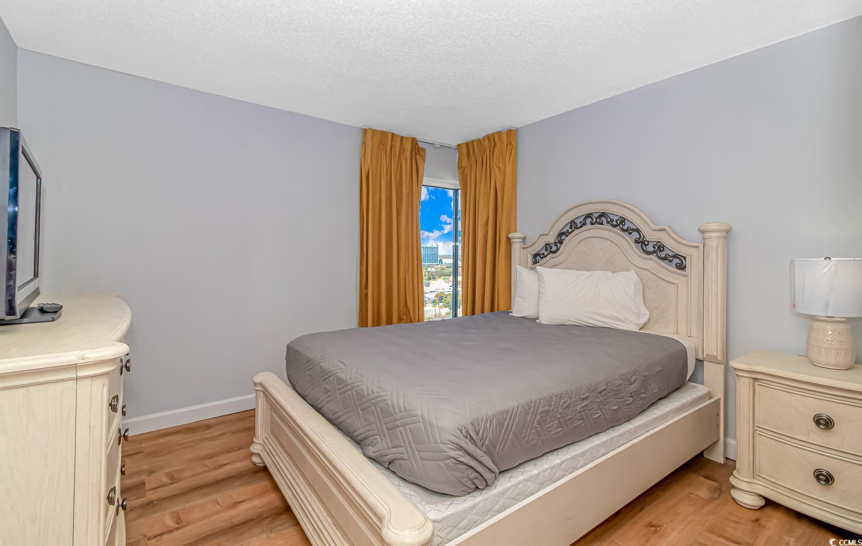 1708 North Ocean Boulevard, Unit PH1 Myrtle Beach, SC 29577 - Photo 10 of 26 Bedroom featuring light wood-type flooring and a t